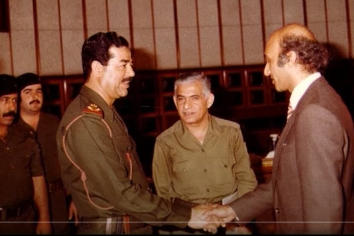 Dr Bashir shaking hands with Saddam Hussein