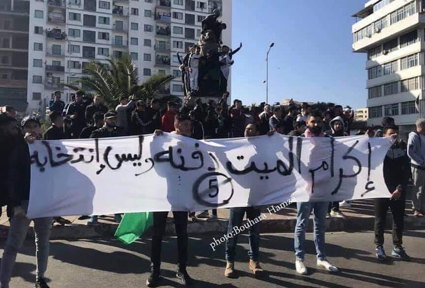Street protest in Algeria. The banner, referring to President Bouteflika's poor health, says: 