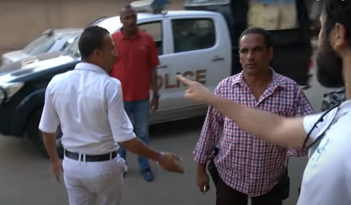 Alex Chacon (on extreme right) confronted in Giza by men who tried to stop him filming