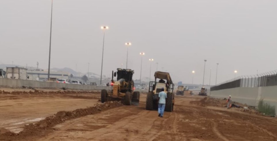 Workers levelling the ground for a new section of track that will bypass the station